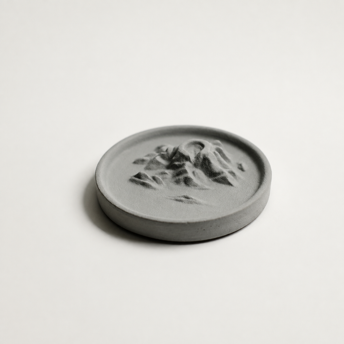 Grey Yunyu Island concrete backflow incense burner on a light background