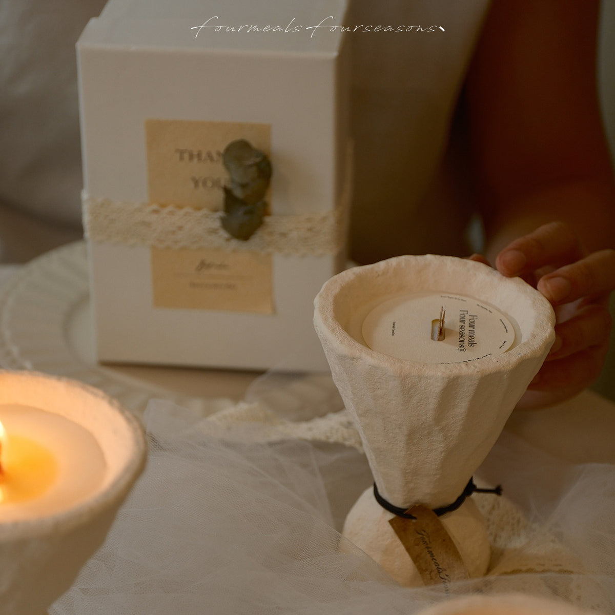 Four Meals Four Seasons sculptural candle beside its gift box