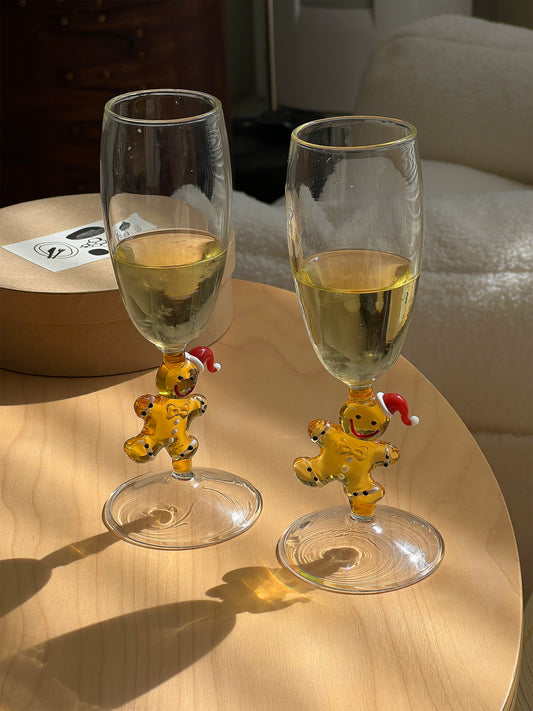 Pair of gingerbread character champagne glasses with festive stems