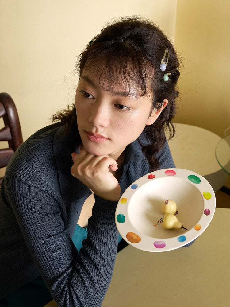 Woman holding a SoftServe colorful candy bean bowl with small fruit