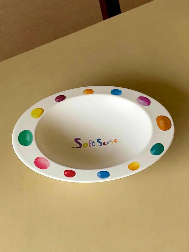 Empty SoftServe colorful candy bean bowl on a tan surface