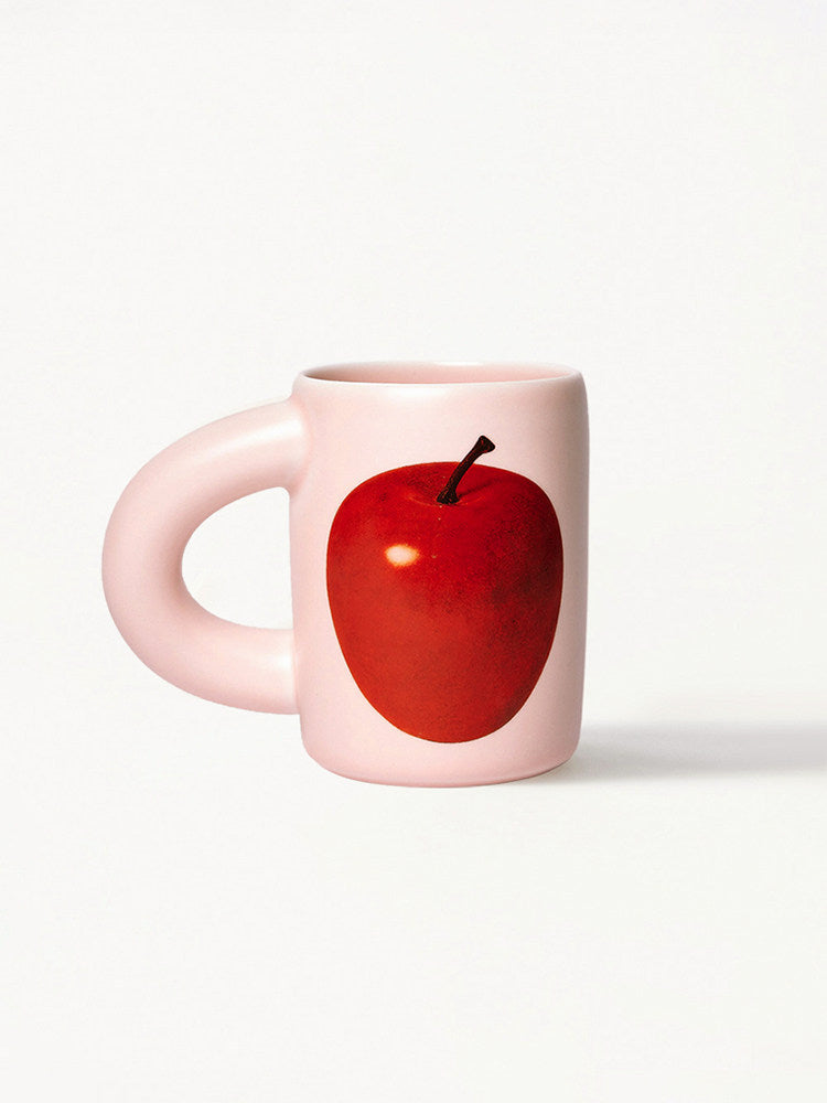 SoftServe red apple ceramic mug with a pink handle on a white background