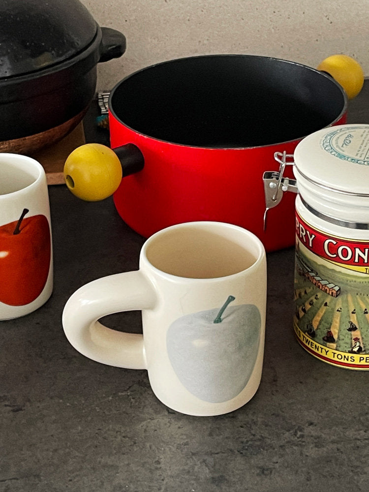 SoftServe apple and pear ceramic mugs arranged on a kitchen counter