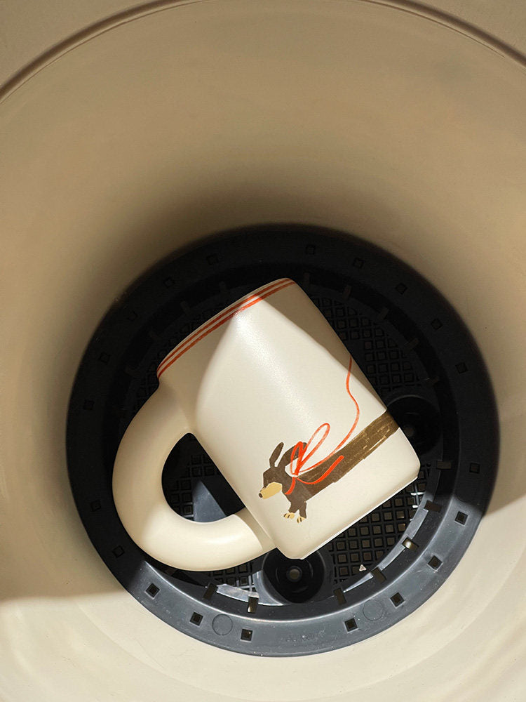 SoftServe dachshund ceramic mug placed in a kitchen sink