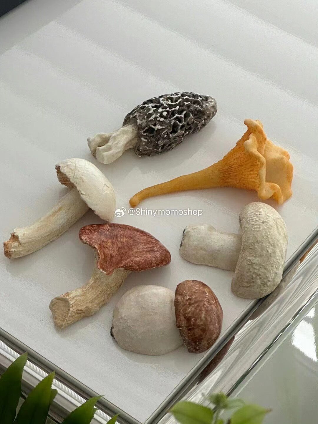 Six mushroom-shaped cutlery rests arranged on a white tray