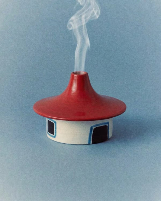 Hand-painted details on the Childish Play ceramic cottage incense burner