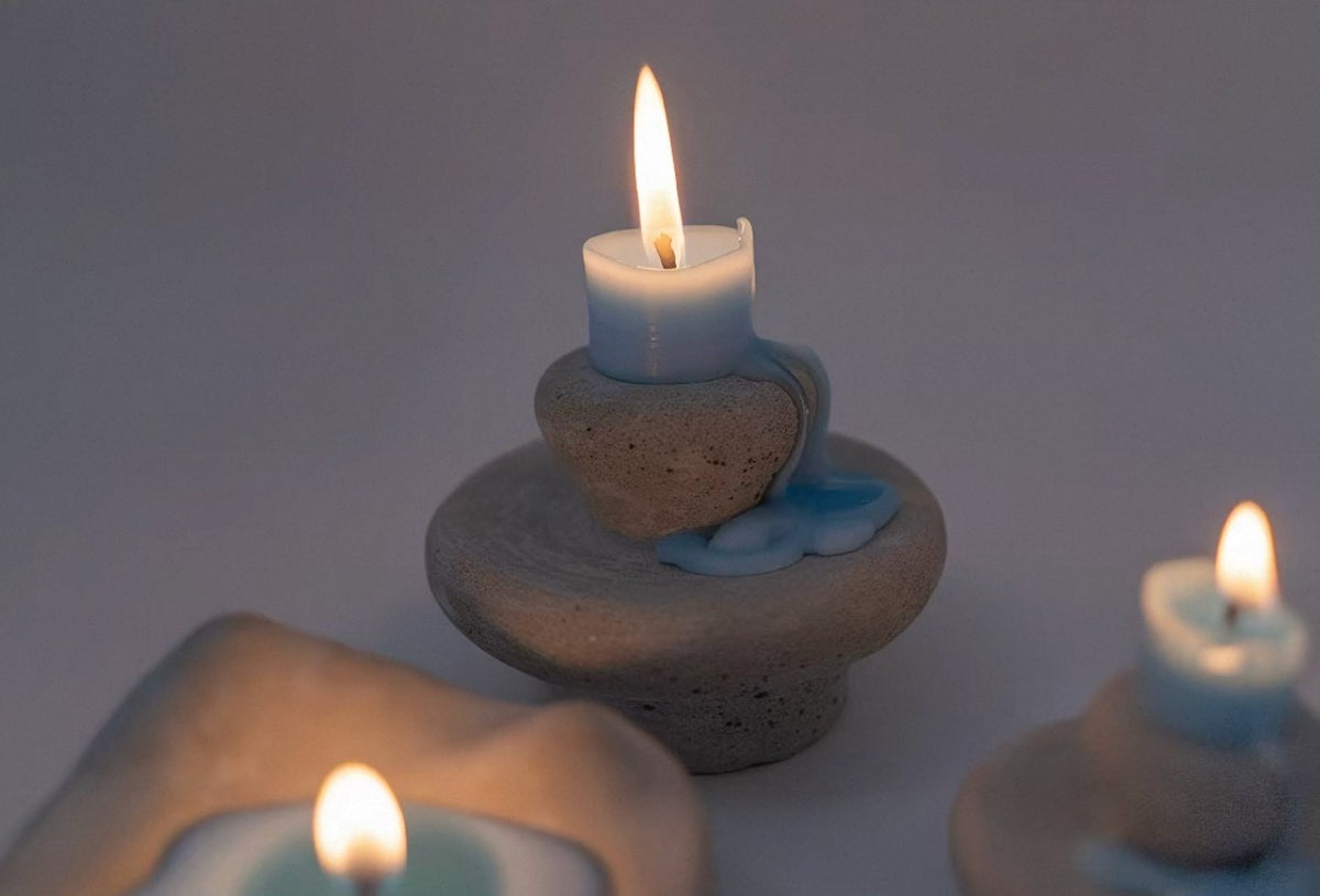 Lit Moon Spring sculptural candle in a dim candlelit setting