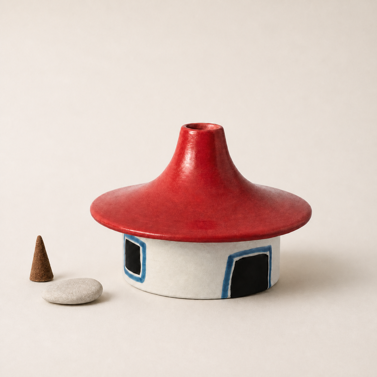 Red roof ceramic cottage incense burner on a warm ivory background