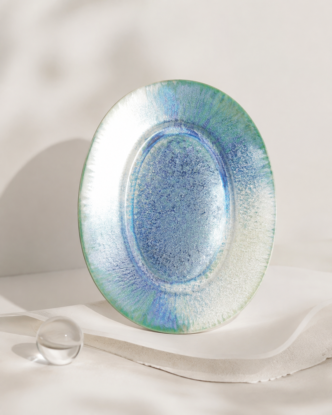 Blue-green reactive glaze detail on PiGoo ceramic plate