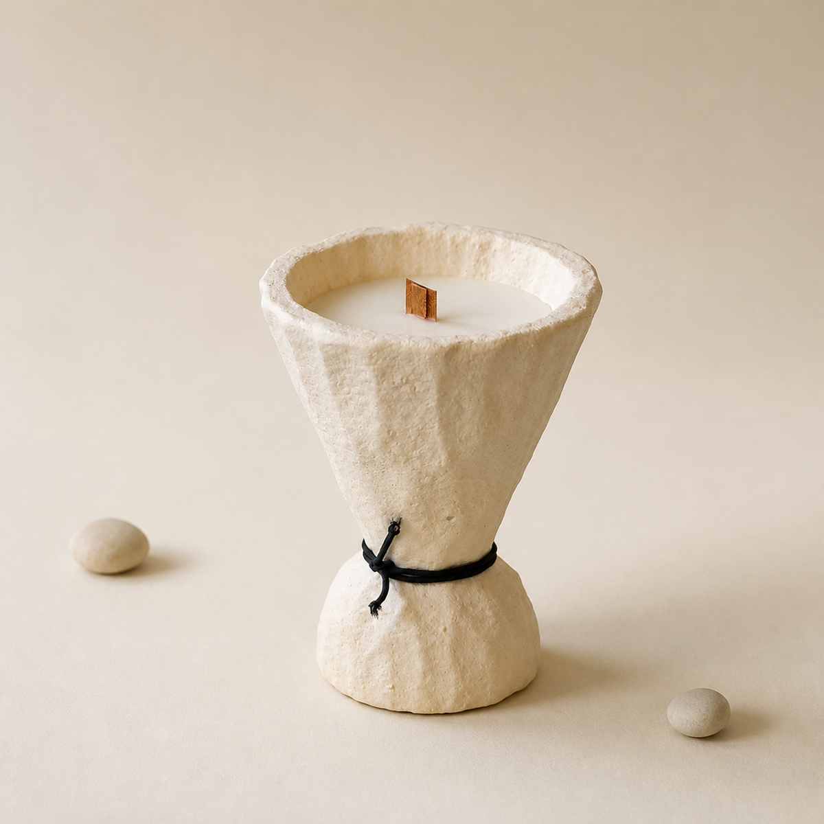 Sculptural off-white cement soy wax candle on a warm white background