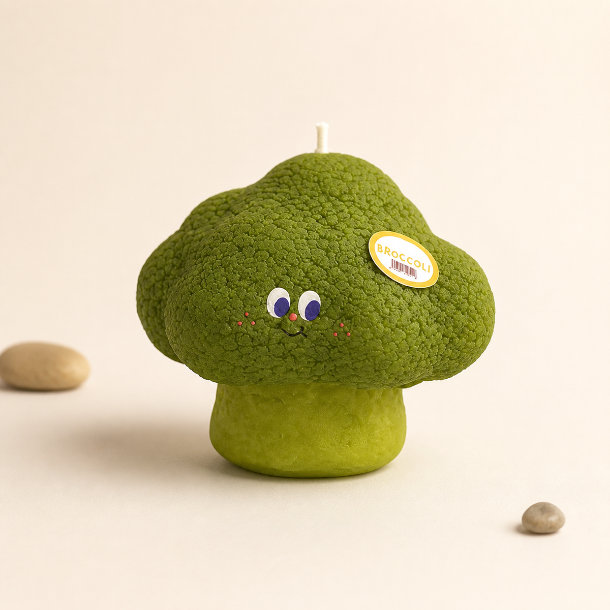 Broccoli sculptural candle on a warm white background
